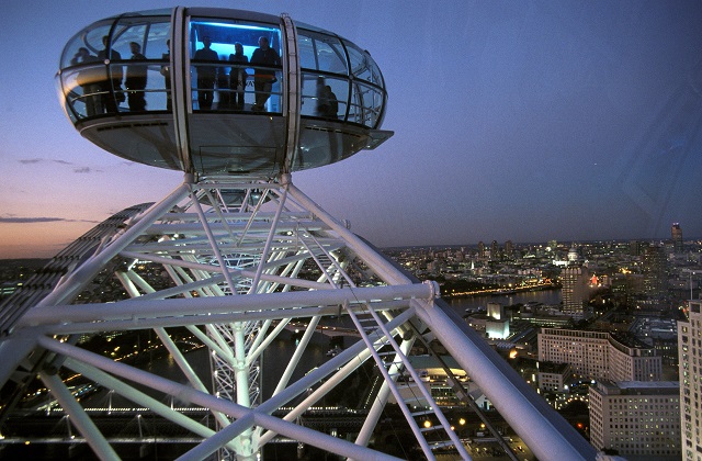 A pod on the London Eye high above the London skyline at night.